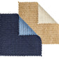 Two Vista Reversible Placemats by Kim Seybert are shown: one navy/light blue, the other tan/cream. Both feature zigzag-cut edges and a basketweave pattern on each side, partially folded to display their reversible design.