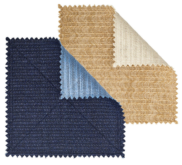 Three fabric swatches with zigzag edges overlap: dark blue, light blue, and beige with a folded corner revealing a lighter underside. This reversible design from the Kim Seybert Vista Reversible Placemat collection echoes a basketweave pattern.