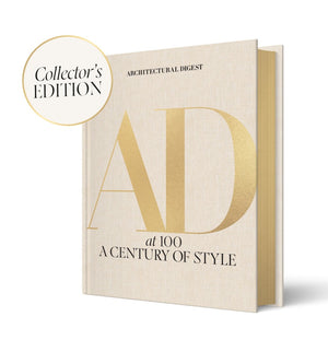 A beige hardcover "Architectural Digest at 100: Collector’s Edition" by Abrams, featuring iconic interiors and a gold "Collector's Edition" badge in the top left corner.