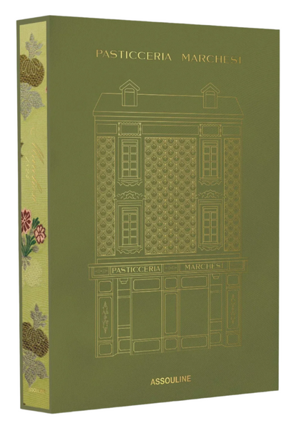 The green hardcover book "Pasticceria Marchesi" by Assouline, featuring a gold-embossed building illustration, celebrates Marchesi 1824's rich legacy with Italian cookies and holiday panettone.