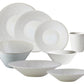 The Jars Vuelta White Pearl Collection features white ceramic plates, bowls, and a mug with a subtle textured pattern and perle glaze—each piece is dishwasher safe for easy cleaning.