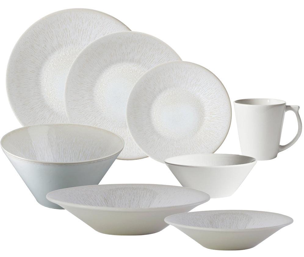 The Jars Vuelta White Pearl Collection features white ceramic plates, bowls, and a mug with a subtle textured pattern and perle glaze—each piece is dishwasher safe for easy cleaning.