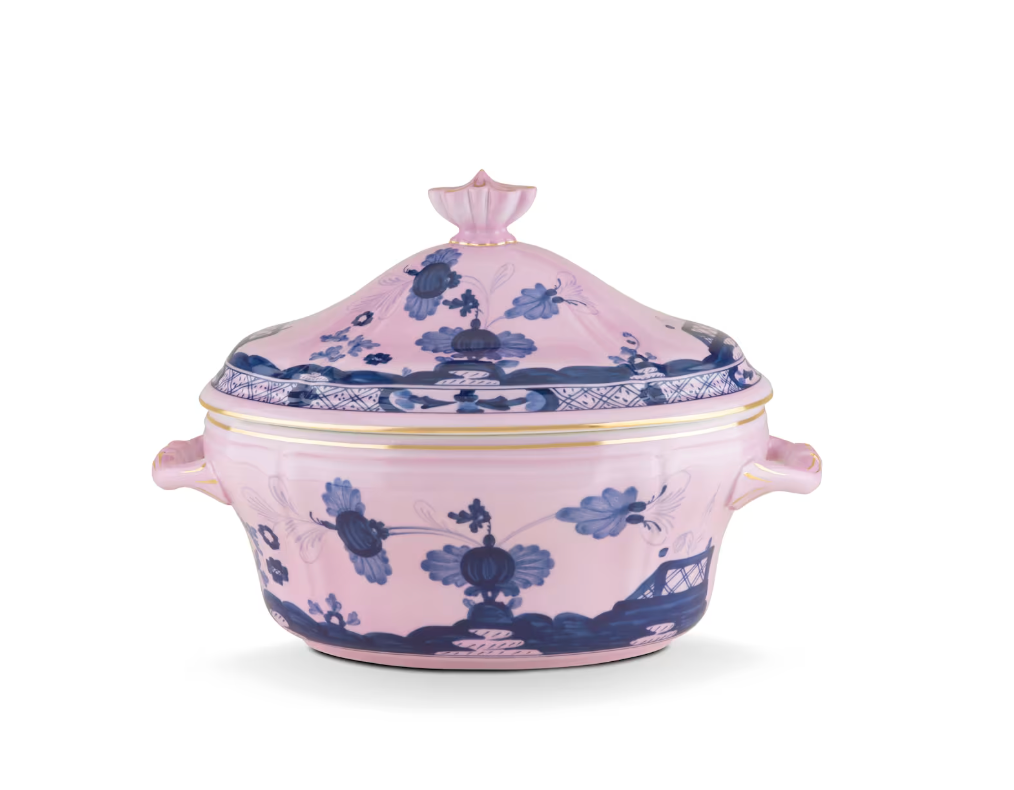 Experience refined dining with the Oriente Italiano Azalea Serveware & Decor Collection by Ginori 1735. This lidded porcelain tureen features two handles and is adorned with blue floral and landscape motifs on a delicate pink background, inspired by the graceful aesthetics of the Oriente Italiano line, and elegantly finished with gold trim accents. Ideal for pairing with matching dinner plates from the same collection.