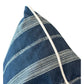 A close-up of the Orlando Stripe Outdoor Pillow by Associated Design, featuring blue fabric with white embroidered horizontal stripes and a crisp white piped edge, crafted from premium materials.