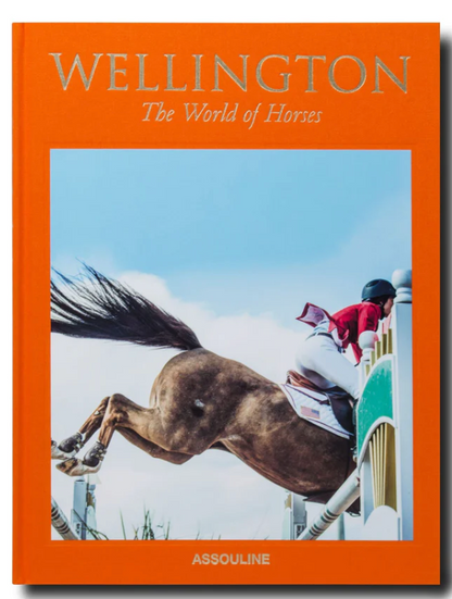 The orange cover of "Wellington: The World of Horses" by Assouline features a horse and rider leaping over an obstacle, capturing the excitement of Wellington, Florida’s famed equestrian shows.