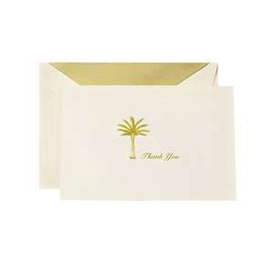 The Crane Thank You Palm Tree Folded Card Set features cream-colored engraved cards with a gold palm tree and text, nestled in matching envelopes with gold lining—the ideal palm tree stationery.