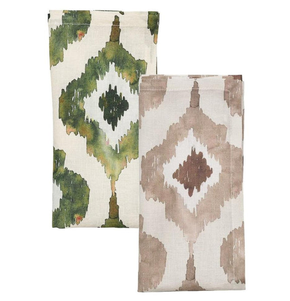 The Kim Seybert Watercolor Ikat Napkin Set from the renowned brand Kim Seybert features two patterned fabric napkins, one with a green and off-white geometric design, and another showcasing a brown and beige taupe Ikat pattern.