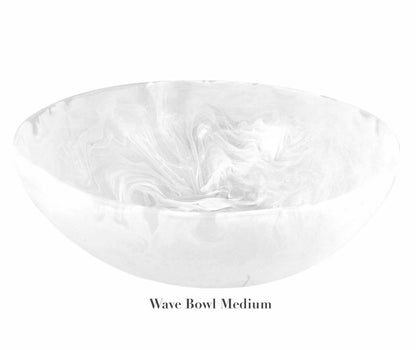 This medium bowl from the White Resin Serveware Collection by Nashi Home features a white marble pattern, smooth curved edges, and is labeled "Wave Bowl Medium" on the underside.