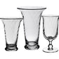 The Waves Floral Vase Collection by William Yeoward Crystal features three clear, textured glass vases of varying heights and shapes, including a spiral design, displayed against a white background.