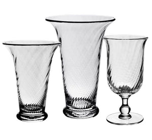 The Waves Floral Vase Collection by William Yeoward Crystal features three clear, textured glass vases of varying heights and shapes, including a spiral design, displayed against a white background.
