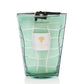 A Baobab Waves Nazare candle in a teal, grid-patterned glass container with a white label featuring a golden lemon tree wood logo.
