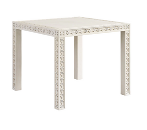 The Mr & Mrs Howard Amy Game Table is a white square table featuring decorative geometric patterns on its edges and legs, ideal for enhancing your game nights. Shown against a plain white background.
