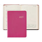 A closed 2027 Weekly Notebook in pink from Graphic Image is placed in front of an open planner displaying a weekly layout for July; both showcase lined pages and calendar sections—making them the perfect elegant appointment book or stylish leather notebook to keep you organized year-round.