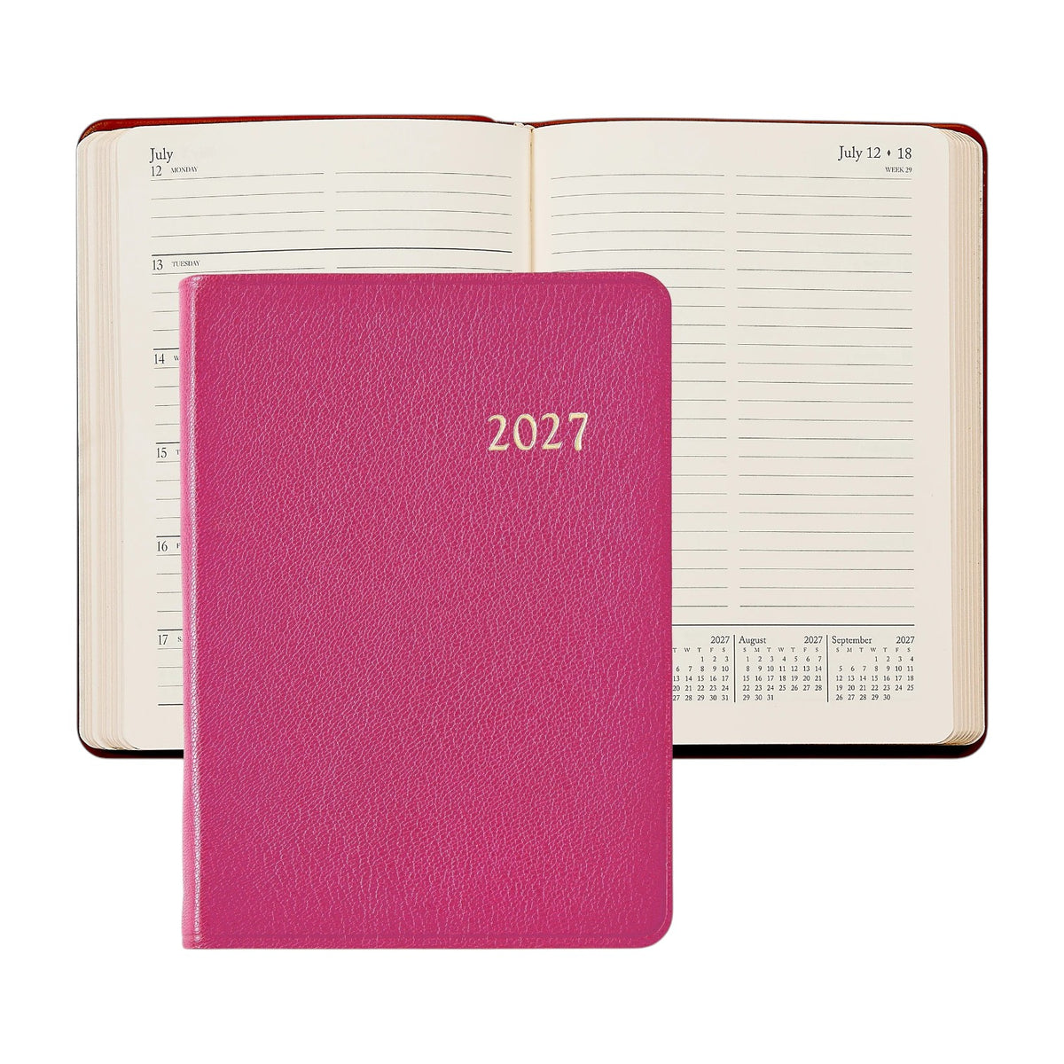 A closed 2027 Weekly Notebook in pink from Graphic Image is placed in front of an open planner displaying a weekly layout for July; both showcase lined pages and calendar sections—making them the perfect elegant appointment book or stylish leather notebook to keep you organized year-round.