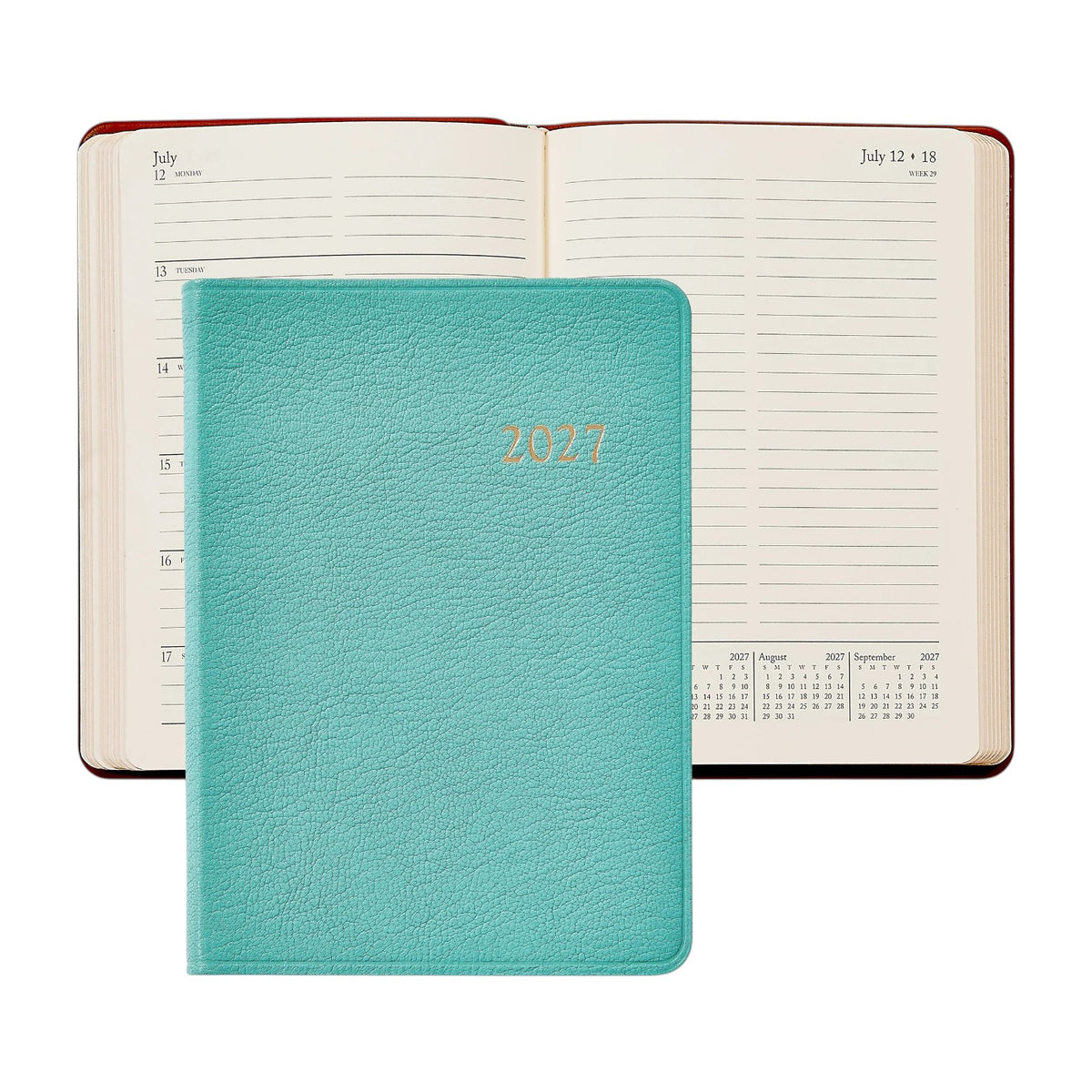 A Graphic Image 2027 Weekly Notebook in teal is placed on top of an open weekly appointment book displaying the week of July 12–18, with calendar overviews for July, August, and September 2027 visible.
