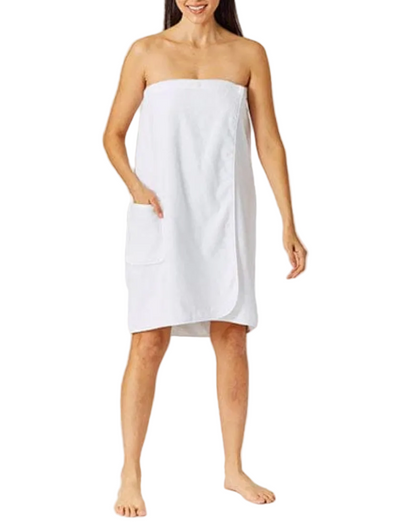 A woman stands barefoot in a Weezie Towels White Towel Wrap with a pocket, providing a customizable, hands-free experience against a white background.