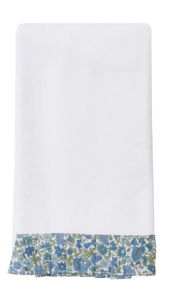 A white cloth napkin trimmed with blue, green, and white Liberty London fabric echoes the elegance of Weezie Towels' Weezie x Liberty London Powder Bath Towel—perfect for pairing with plush, absorbent terry linens.