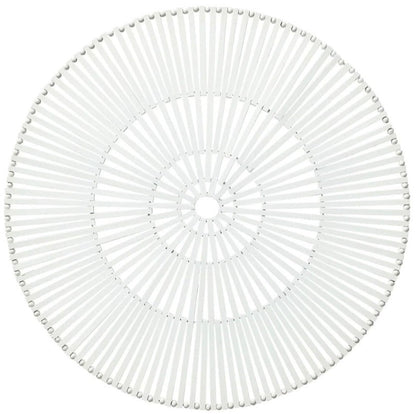 The Kim Seybert Spoke Placemat is a white bamboo placemat with radiating slats and a central hole, arranged in a modern geometric pattern for an organic look.