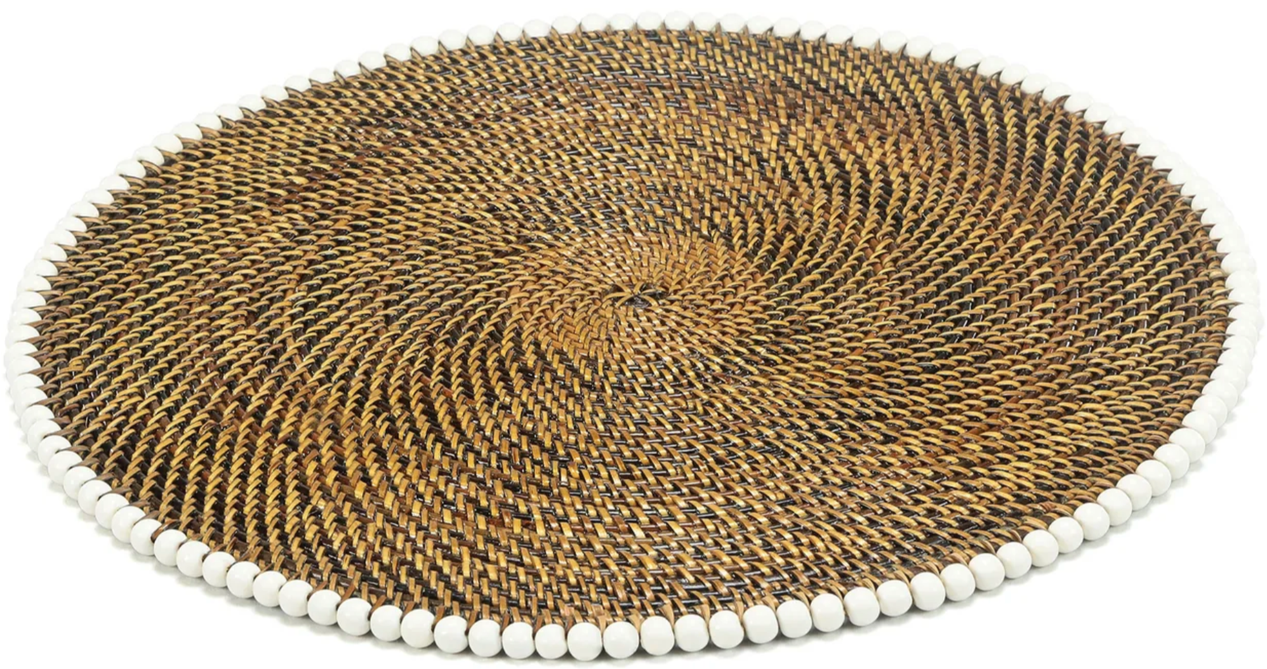 The Calaisio Round Placemat features a handcrafted spiral design in brown tones, made from natural vines and accented with evenly spaced small white beads along the edge.