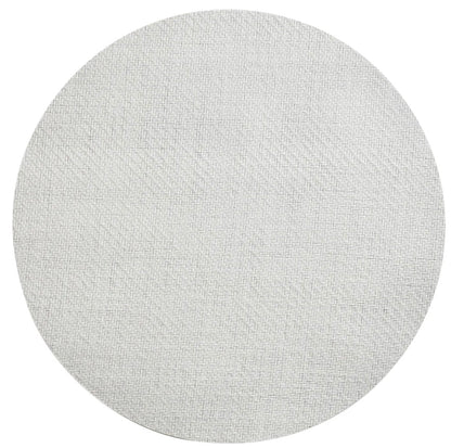 The Kim Seybert Saigon Placemat is a round, light gray swatch with a subtle woven texture inspired by Vietnamese plaiting, shown on a plain white background.