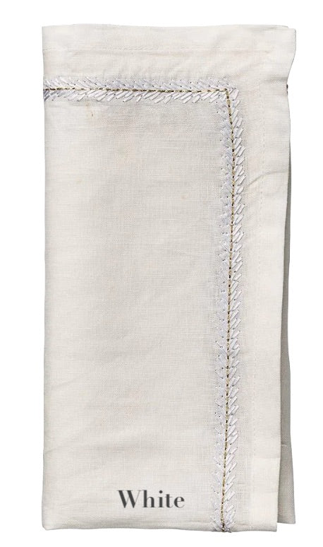 A folded white linen napkin from the Jardin Napkin Set by Kim Seybert, featuring visible edge stitching and "White" embroidered at the bottom.