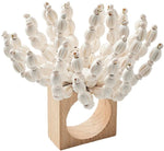 The Reed Napkin Ring by Kim Seybert features wooden beads and white strands, artfully arranged for a coastal-inspired decor accent.