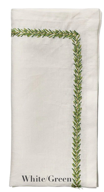 A folded white linen napkin from the Kim Seybert Jardin Napkin Set, featuring green leaf embroidery on two edges. "White/Green" text appears at the bottom.