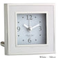 The Square Silver Alarm Clock Collection by Addison Ross features a silver and white design, displays 10:09, and is ideal for a bedside table.