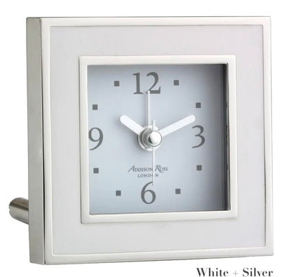 The Square Silver Alarm Clock Collection by Addison Ross features a silver and white design, displays 10:09, and is ideal for a bedside table.