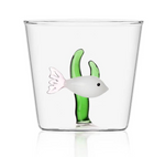 From the Marine Garden Drinkware Collection by Ichendorf Milano: a clear glass tumbler with an embedded handmade white glass fish and two green seaweed stalks.