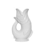 The Original Gluggle Jug's Fish Gluggle Jug Collection features white ceramic fish-shaped jugs with open mouths and detailed scales and fins—a true icon of British design.