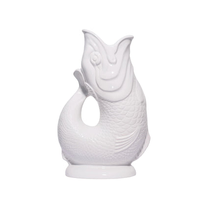 The Original Gluggle Jug's Fish Gluggle Jug Collection features glossy white ceramic jugs shaped like fish, with detailed scales and an open-mouth spout—a true British design icon.