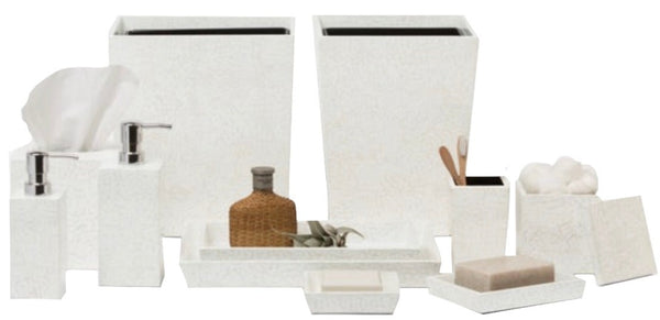 A collection of white lacquered Pigeon & Poodle Callas bathroom accessories including a soap dispenser, tissue box cover, trash bins, and storage containers for various toiletries.