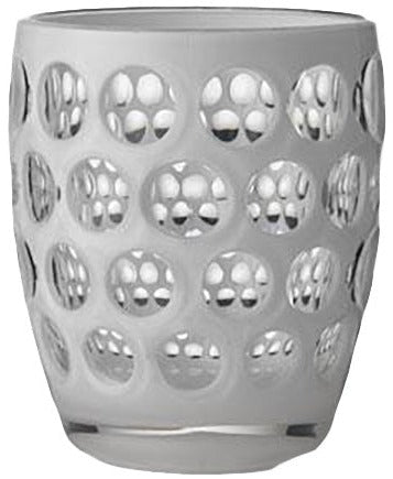 The Lente Acrylic Dinnerware Collection by Mario Luca Giusti features a clear glass tumbler with a frosted surface and circular indents, ideal for outdoor entertaining or pairing with blue or white pieces.