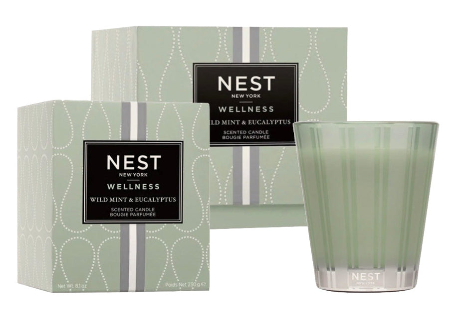 A Nest Wild Mint & Eucalyptus Candle from the Wild Mint & Eucalyptus Candle Collection is displayed beside its matching box, emphasizing the refreshing scents of wild mint and eucalyptus.
