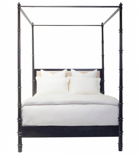 A black four-poster Willa Raffia Bed, King by Oly with a hardwood frame, white bedding, and four white pillows, featuring an elegant upholstered headboard.