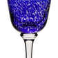A blue bowl goblet with a clear stem from the Vanessa Blue Drinkware Collection by William Yeoward Crystal, featuring colored glass and a white textured swirl pattern that creates an optical illusion.