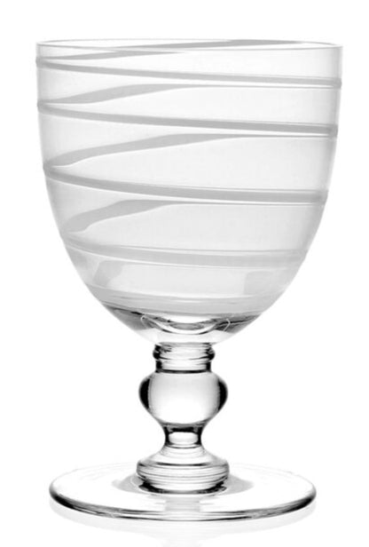 The Bella Bianca Collection by William Yeoward Crystal features a clear glass goblet with a round base and stem, elegantly etched with a white spiral. Glasses may also include a Proposition 65 warning.