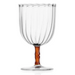 The Rivoli Drinkware and Tealight Collection by Ichendorf Milano features a clear glass goblet with vertical grooves, a wavy rim, brown stem, and round base—a stunning example of hand-crafted glassware.