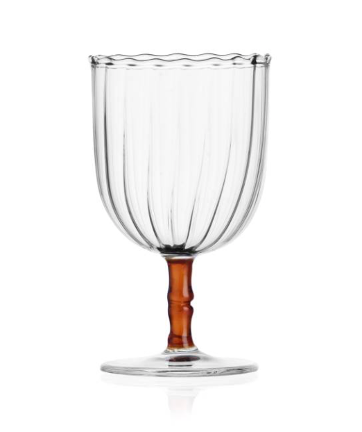 The Rivoli Drinkware and Tealight Collection by Ichendorf Milano features a clear glass goblet with vertical grooves, a wavy rim, brown stem, and round base—a stunning example of hand-crafted glassware.