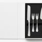 The Essentials Cake Tools by PrintWorks includes a knife, two small forks, and a pie server in foam cutouts, with an empty white panel on the left—an ideal set to elevate your kitchen decor.