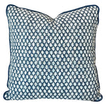 The Burma Indigo Outdoor Pillow by Associated Design features a dark blue and white geometric leaf pattern, piped edges, and premium craftsmanship—perfect for elevating any space.