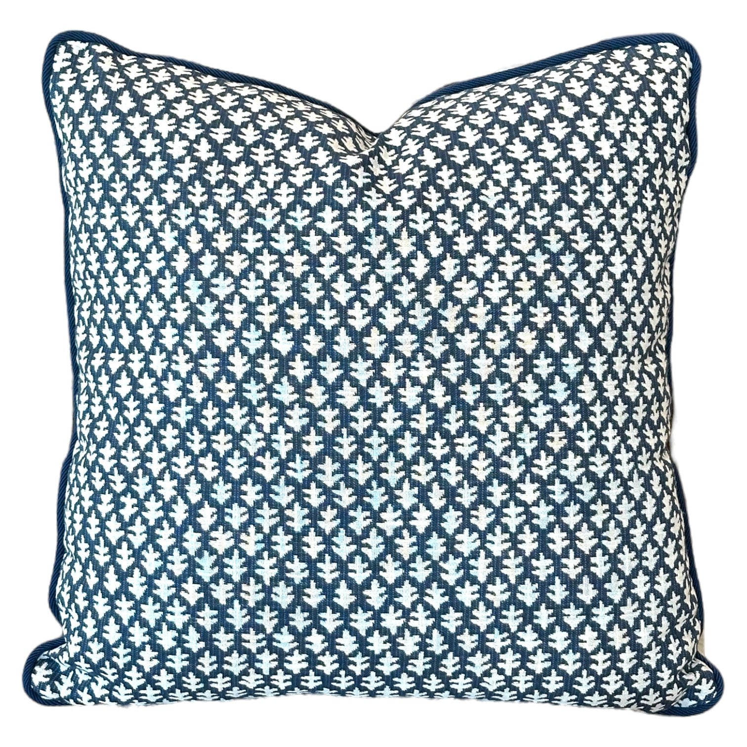 The Burma Indigo Outdoor Pillow by Associated Design features a dark blue and white geometric leaf pattern, piped edges, and premium craftsmanship—perfect for elevating any space.
