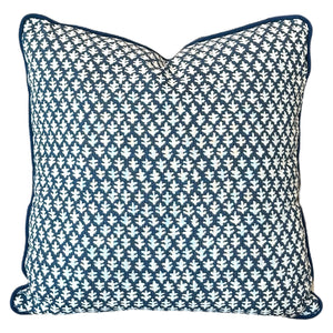 The Burma Indigo Outdoor Pillow by Associated Design features a dark blue and white geometric leaf pattern, piped edges, and premium craftsmanship—perfect for elevating any space.