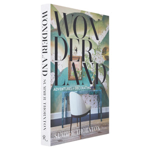 “Wonderland Adventures in Decorating” by Rizzoli is a renowned interior design book that showcases Summer Thornton’s signature maximalist style, with a cover featuring a striking chair set against a lush green wall.