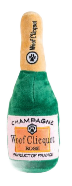 The Haute Diggity Dog Woof Clicquot Rosé Champagne Bottle toy, extra large, mimics a champagne bottle with paw prints and includes a squeaker for hours of fun.