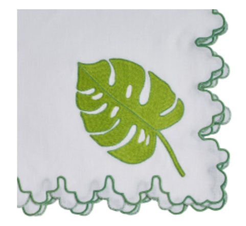 Haute Home's Big Green Leaf Napkin Set includes 4 white linen napkins featuring a delicate green leaf pattern and sophisticated scalloped edges.