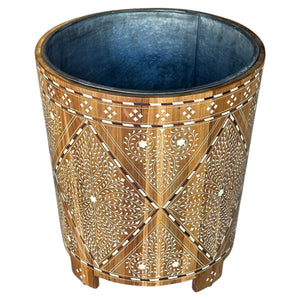 The Bojay Large Wood and Bone Planter is a cylindrical wooden piece with intricate white geometric and floral inlay, plus a metal-lined interior, bringing elegant style to your space.
