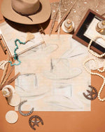 The Acrylic Puzzle by Tart by Taylor features abstract cowboy hats and comes with jewelry, drinks, horseshoes, and decorative items—a unique addition to your home decor.