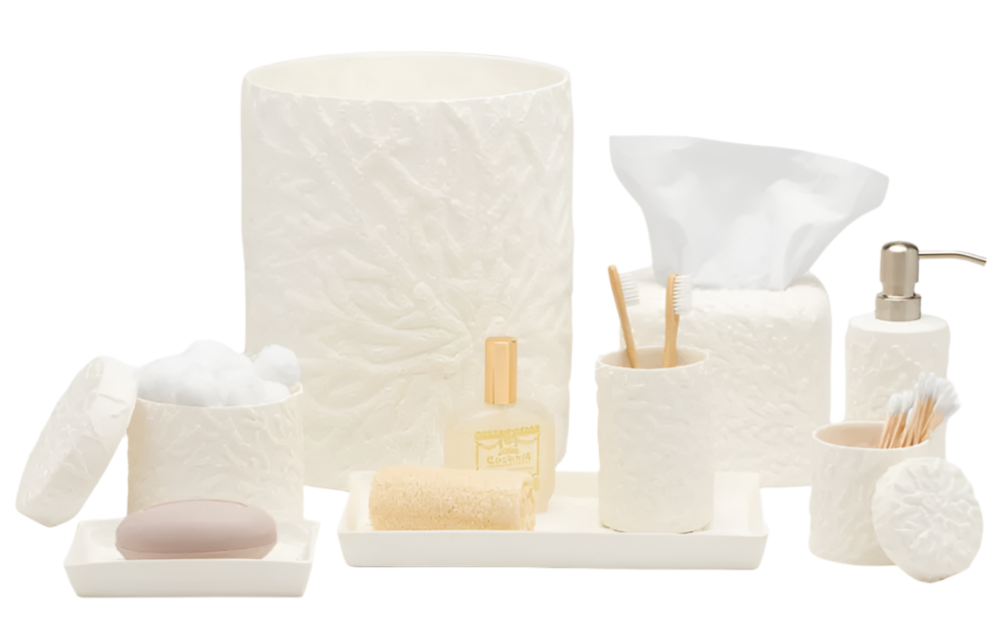 The Alanya White Bath Collection by Pigeon & Poodle showcases coral-patterned white porcelain accessories—waste bin, tissue box, containers, soap dish, toothbrush holder, lotion dispenser, and tray—on a white background.